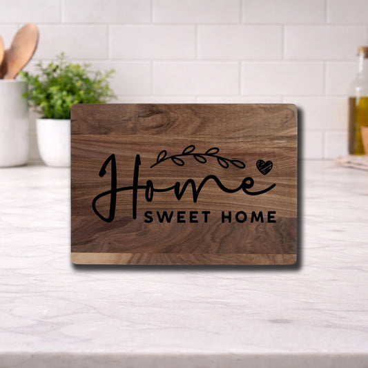 Engraved cutting board with the phrase 'home sweet home' beautifully designed for kitchen use.