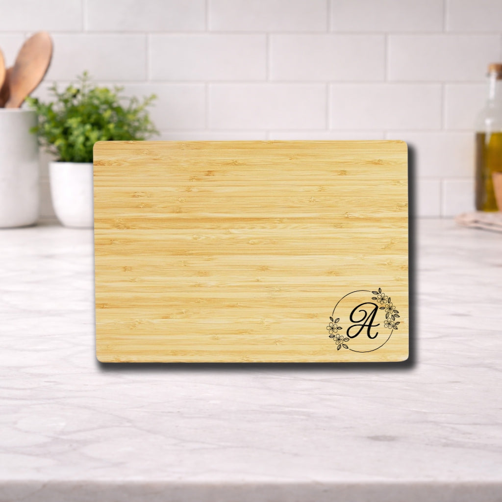 Engraved Cutting Board with Custom Monogram displayed on a kitchen countertop, featuring an elegant initial design.