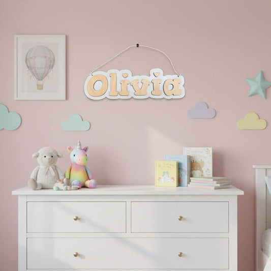 Personalized wooden name wall sign for a nursery, featuring the name Olivia in a light wood finish.
