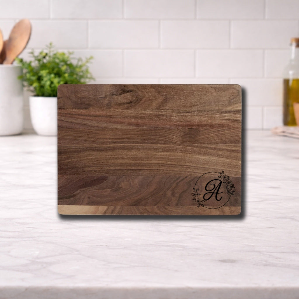 Engraved Cutting Board with Custom Monogram displayed on a kitchen countertop, featuring an elegant initial design.