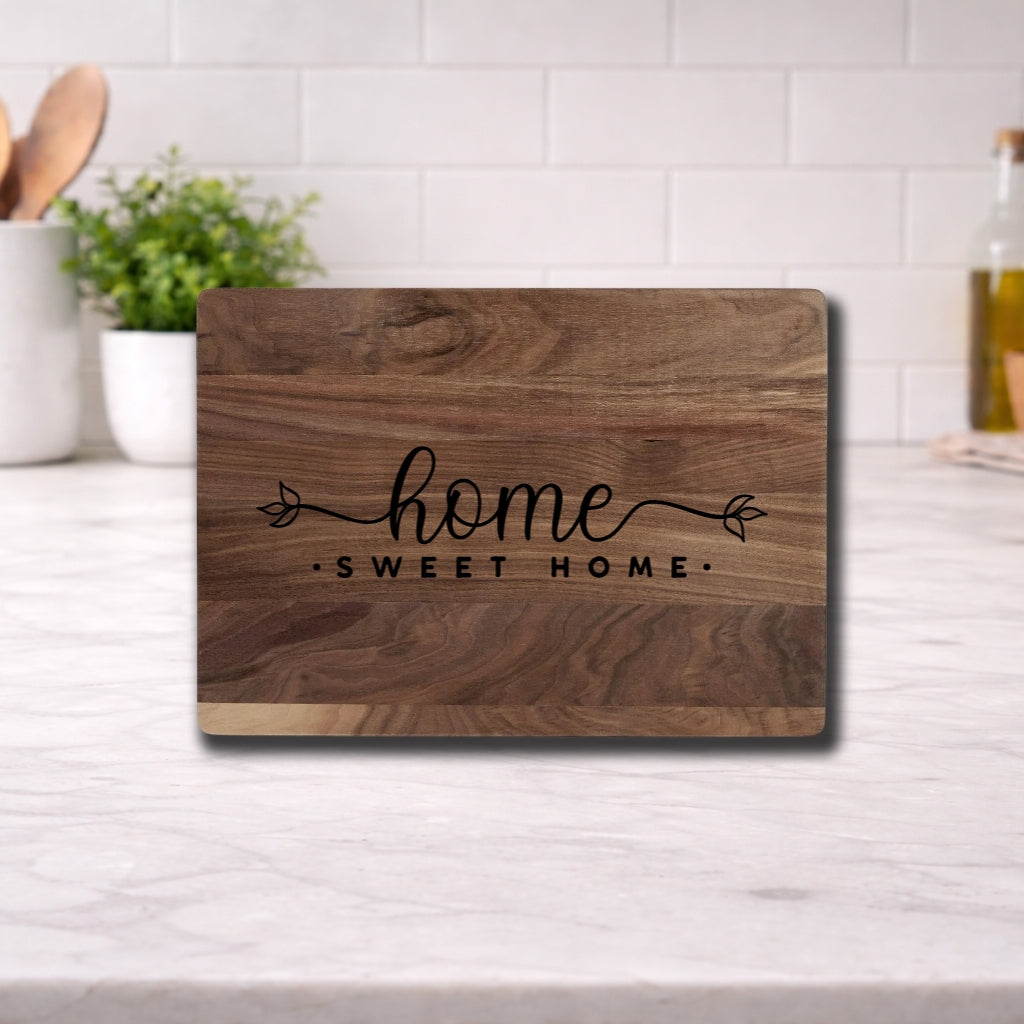 Engraved cutting board with the phrase 'home sweet home' beautifully designed for kitchen use.